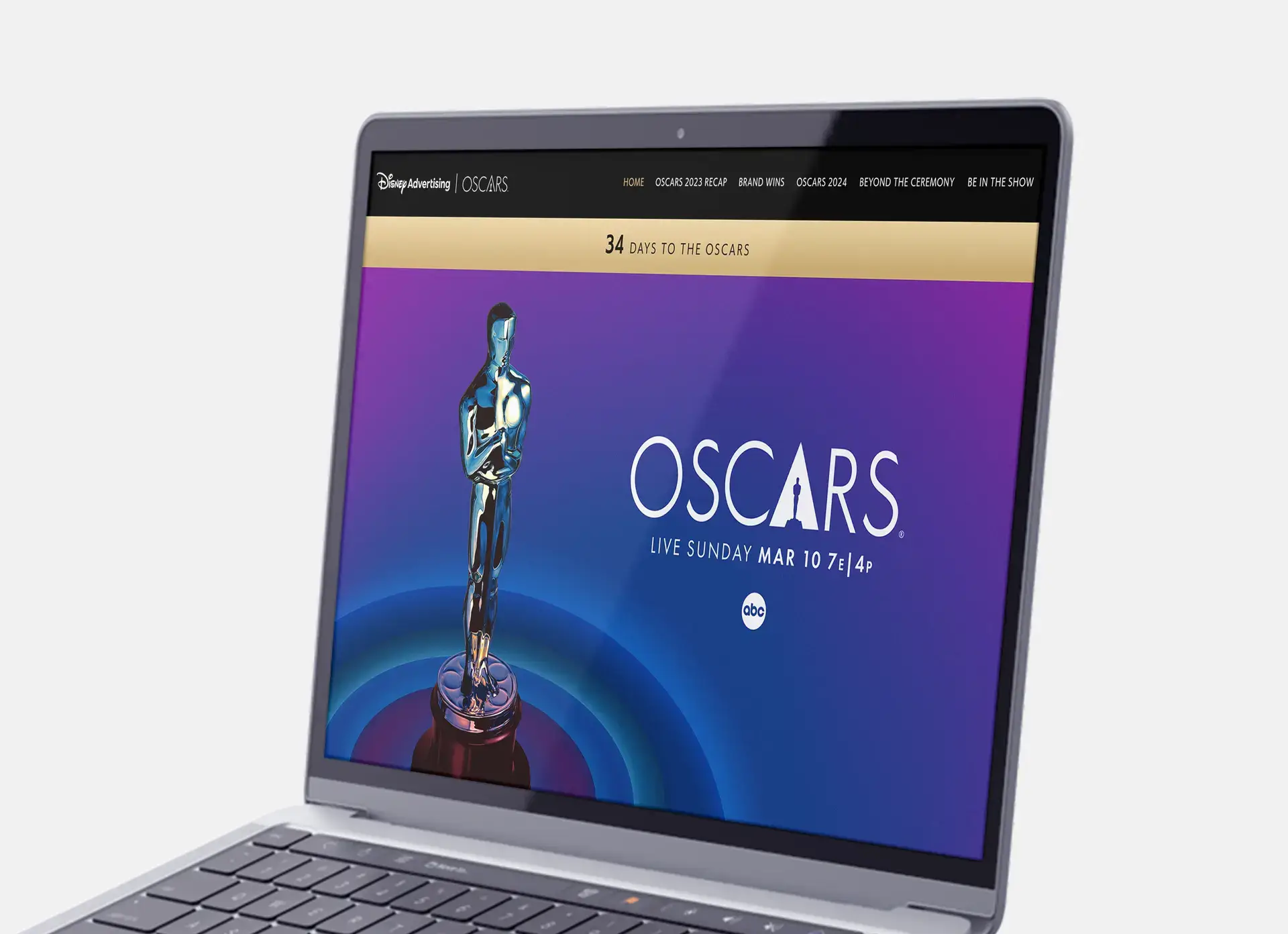 Closeup of a laptop showcasing the Homepage navigation, countdown clock, and header on the Pfizer and Oscars Partnership website